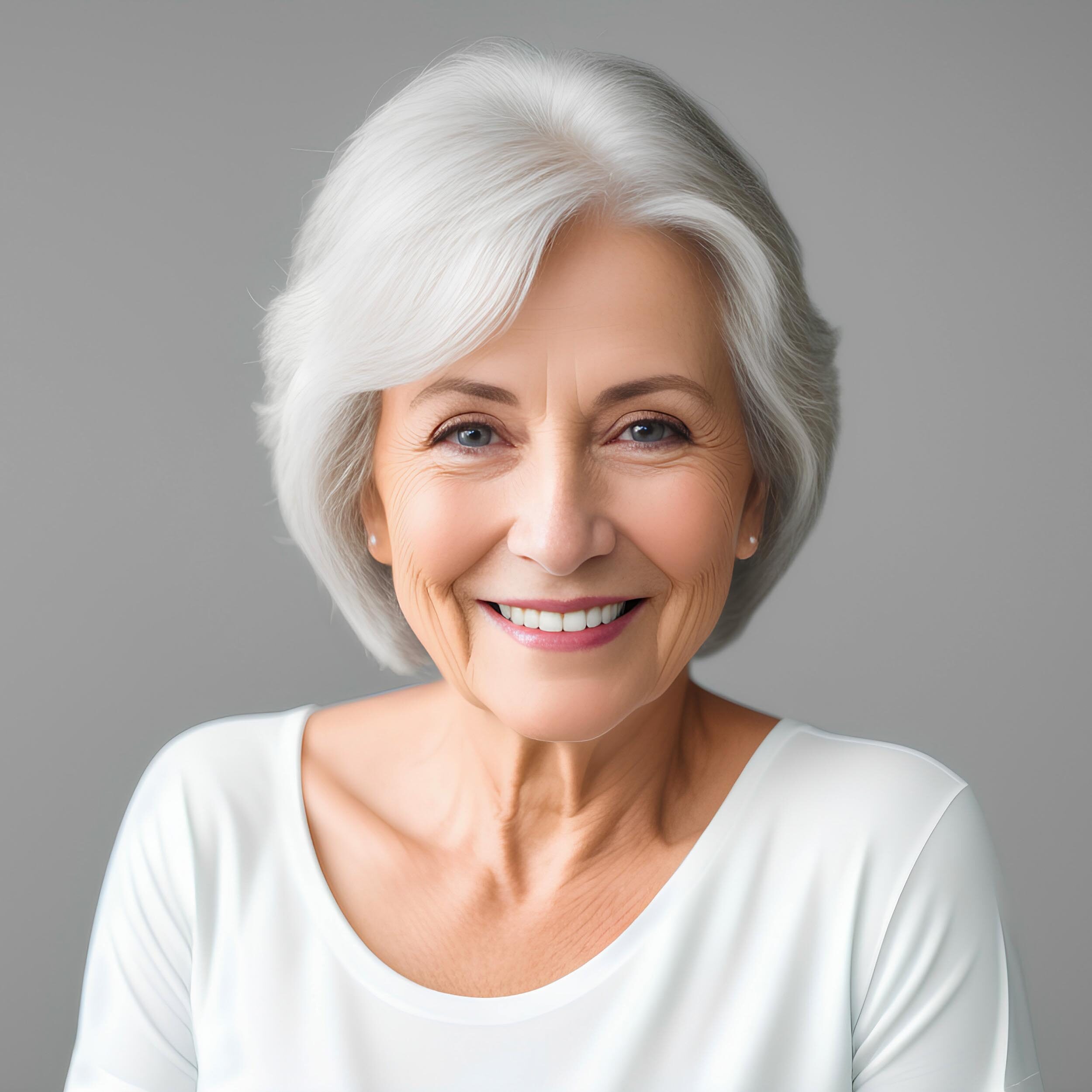 Happy confident senior woman with natural skin, healthy grey hair and white teeth on Grey background.